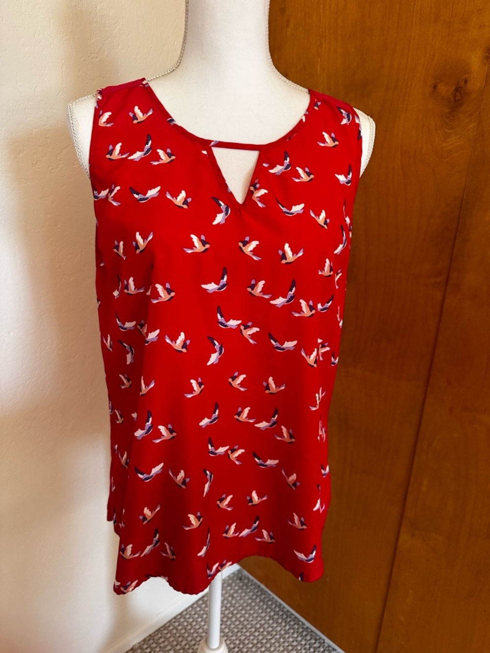 Red sleeveless top with bird print